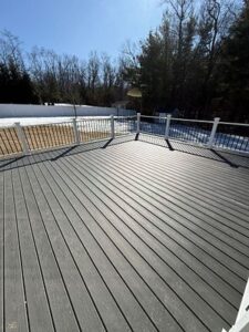 Spacious composite deck surface completed through Custom Deck Construction, offering a clean and modern outdoor area.